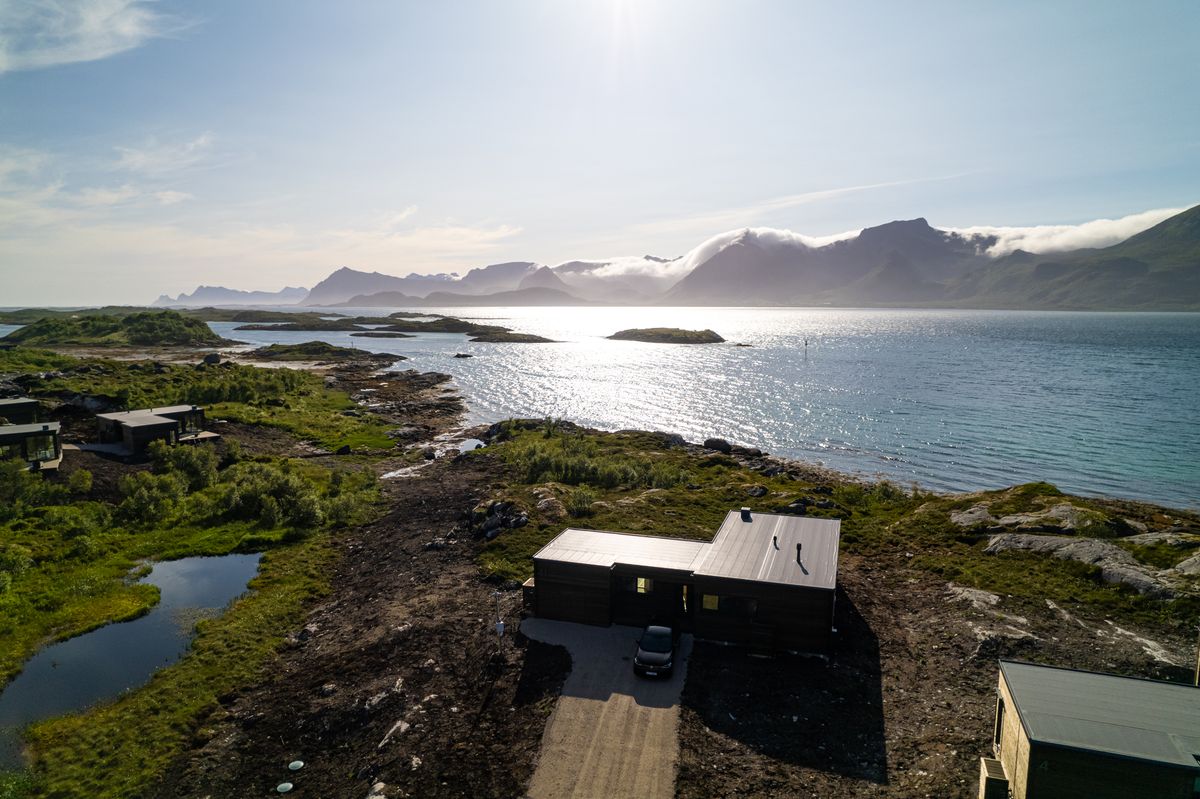 Lyngvær from the air: the house, the shoreline, calm sea and islands in the distance