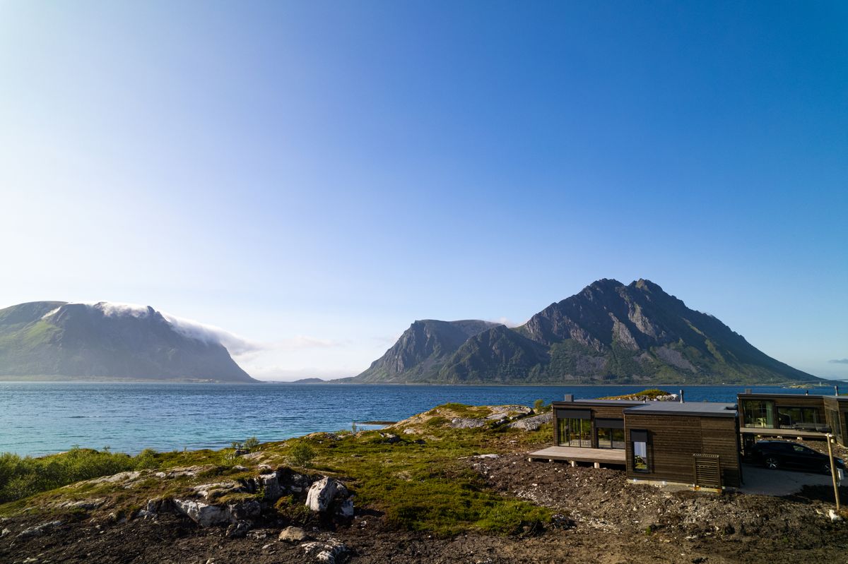 The Lyngvær house on the shore with a wide view across the water to the mountains