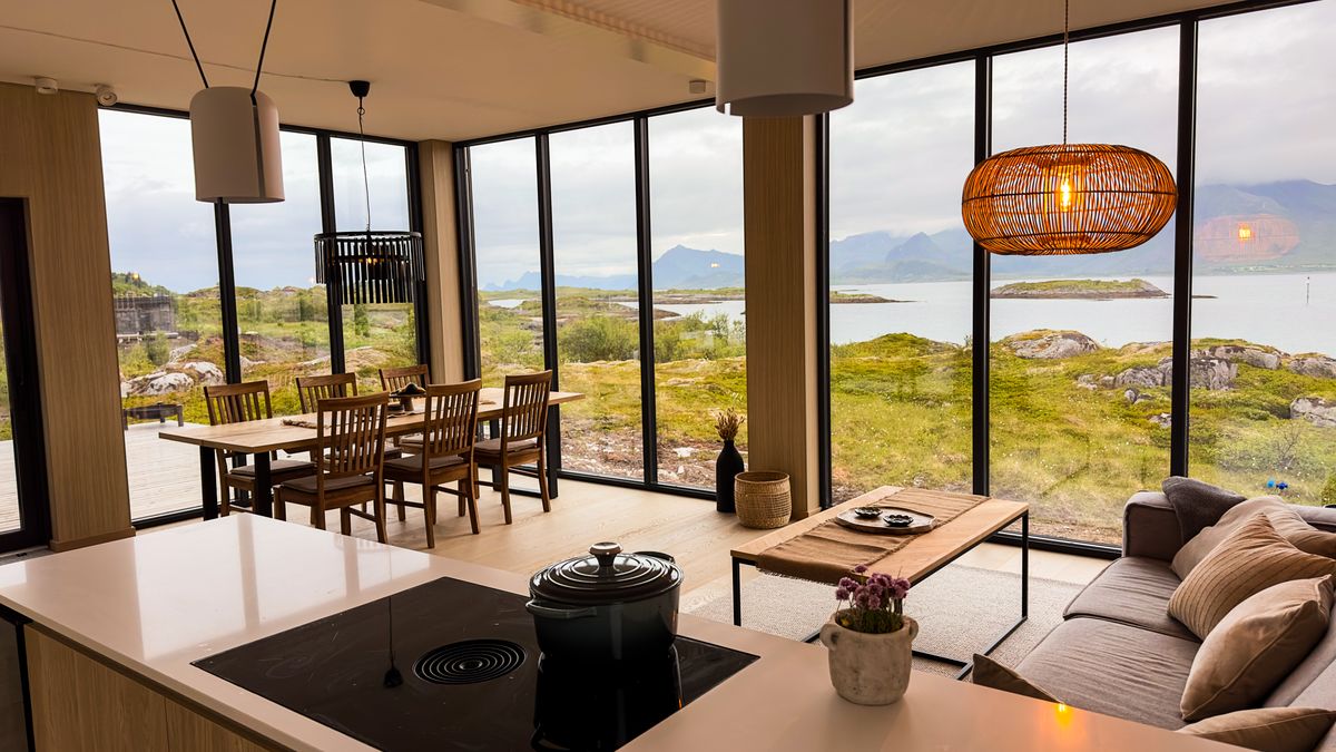 Kitchen island in Lyngvær with the dining area and sea view behind