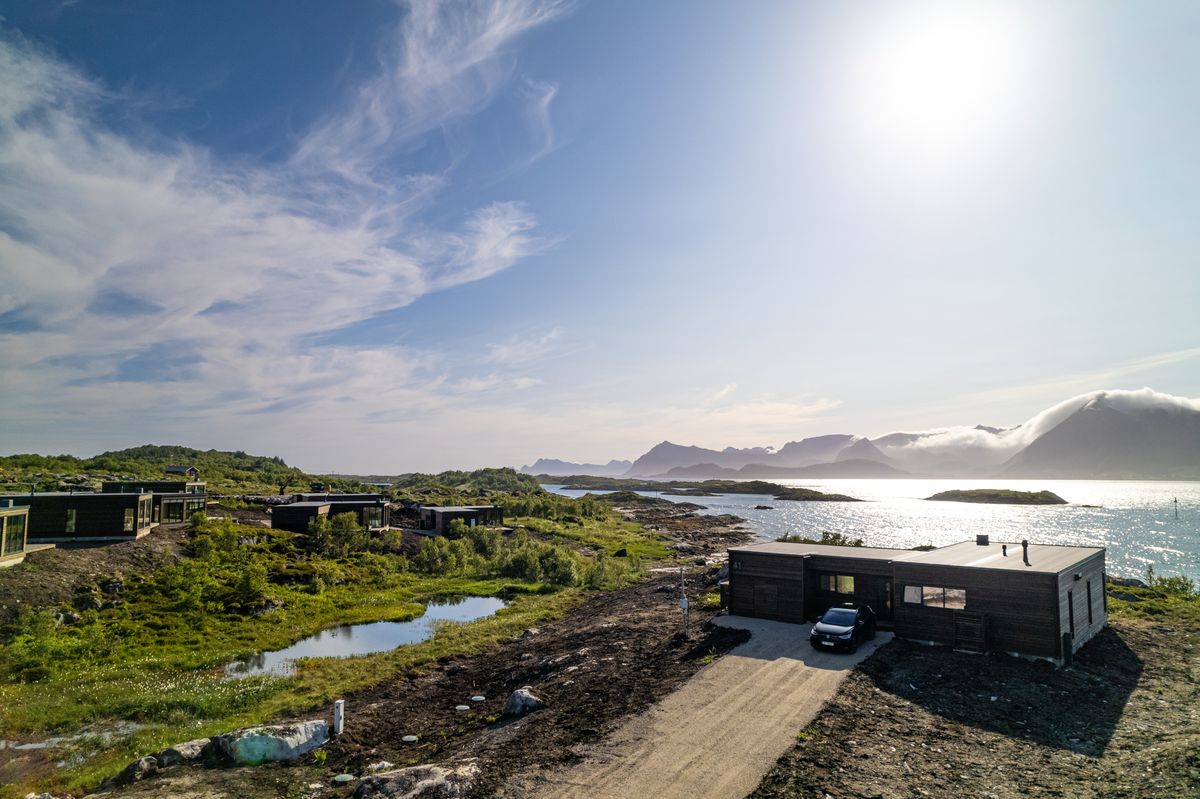 Sunlit shoreline and water at Lyngvær