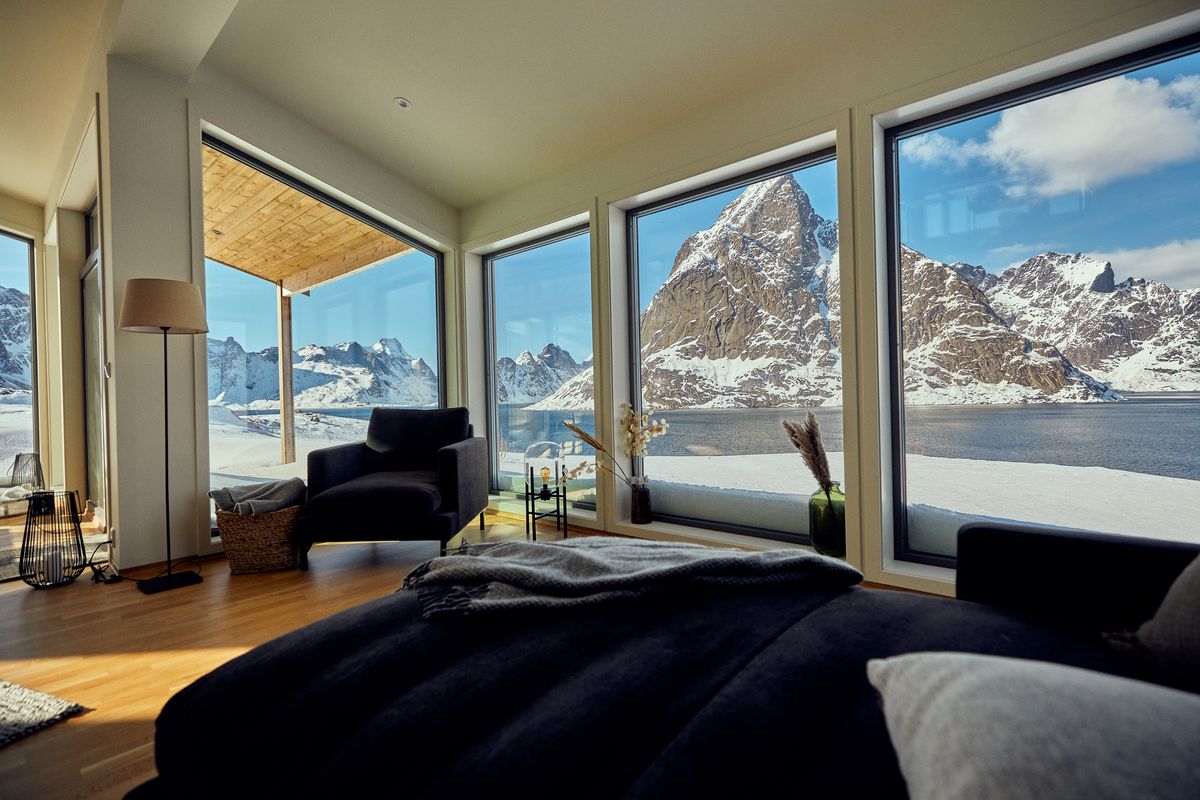 Bedroom in Reine with large windows facing snowy peaks